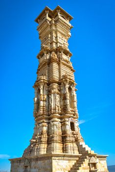 a tall tower with statues on the sides