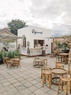 an outdoor patio with tables and chairs