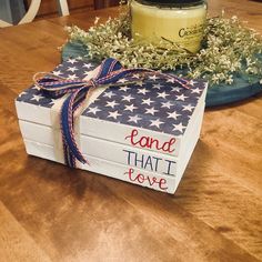 a patriotic box sitting on top of a wooden table next to a jar of jam