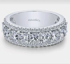 an 18k white gold wedding band with princess cut diamonds