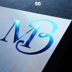 a close up of the letter b on a paper with blue ink and silver foil