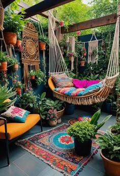 an outdoor area with plants and hammock hanging from the ceiling, potted plants on either side