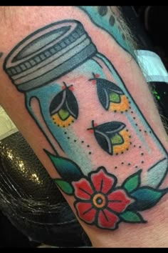 a person with a tattoo on their arm has an image of a mason jar in it