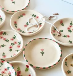 many small plates with flowers painted on them