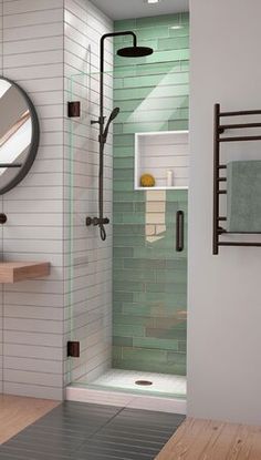 a walk in shower sitting next to a bathroom sink and mirror on top of a wooden floor