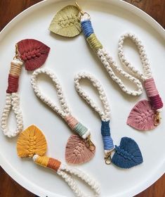 several necklaces are laid out on a white plate