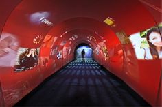 a long tunnel with pictures on the walls