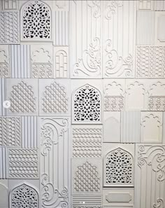 a white wall with many different designs on it