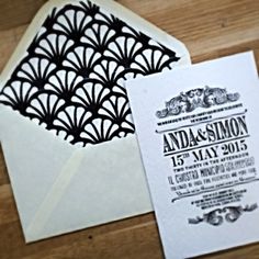 an open envelope with a wedding card on it and a laser cut design in the front