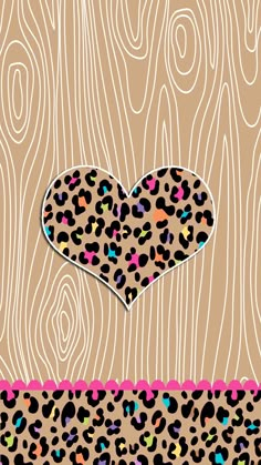 a leopard print heart on a wood background