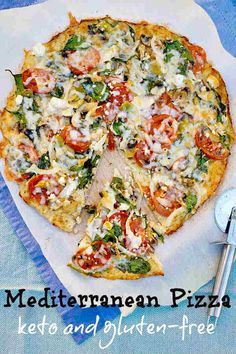 a pizza with several toppings cut into slices on a paper towel next to a fork and knife