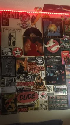 a wall covered with posters and lights