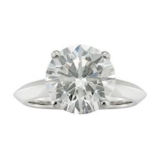 a round brilliant cut diamond engagement ring in 18k white gold, set with a tapered shans