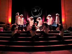 a group of people standing on top of a set of steps in front of a stage