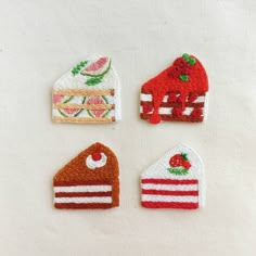 four pieces of embroidered fabric are arranged in the shape of cake, strawberry and pie