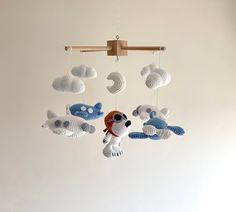 a crocheted mobile with stuffed animals hanging from it