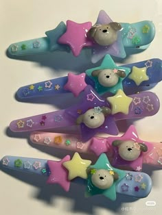 there are five toothbrushes shaped like bears and stars