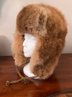 Experience ultimate luxury with our handmade Baby Alpaca Fur Trapper Hat. Crafted in the Andes region of Peru, this hat feels like a cozy cloud hugging your head. Perfect for outdoor activities like hiking, hunting, or living off-grid, it’s loved by hunters for its exceptional warmth—warmer than polar bear fur—while also regulating heat. Stay comfortable without overheating, as it adjusts to keep you warm when needed and cool when it’s not. The hypoallergenic baby alpaca fur on this Alpaca Fur T Brown Hats With Ear Flaps For Outdoors, Brown Hats With Ear Flaps For Outdoor Activities, Warm Brown Hats For Outdoor Activities, Warm Brown Hat For Outdoor Activities, Sheepskin Hats With Ear Flaps For Outdoor, Sheepskin Outdoor Hat With Ear Flaps, Adjustable Alpaca Hat For Outdoor, Alpaca Hat For Outdoor Winter Use, Winter Outdoor Alpaca Hat