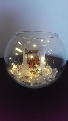 a glass bowl filled with ice and lights