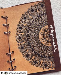 an open notebook with intricate designs on it