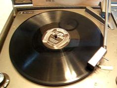 an old record player is sitting on the table