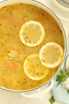 a pot filled with soup and sliced lemons