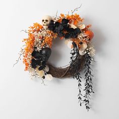 a wreath with skulls and flowers on it