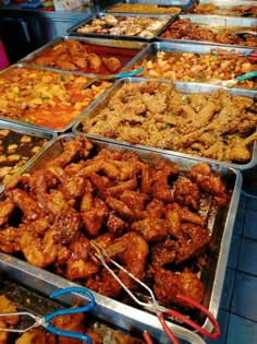 several trays filled with different types of food on top of a table next to each other