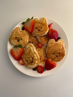 some pancakes with strawberries and teddy bears on them