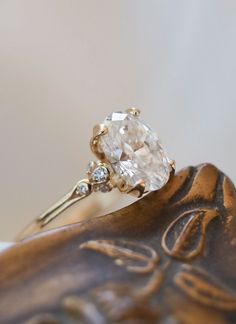 a close up of a ring on top of a statue with a diamond in it