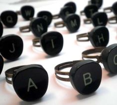 several black rings with letters on them are arranged in the shape of alphabet's