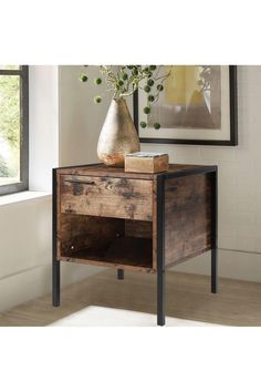 a wooden table with a vase on top of it next to a window sill