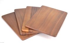 three wooden cutting boards sitting on top of each other