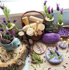 various items are arranged on the table with flowers and lavenders in vases next to them