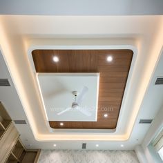 the ceiling in this room is made of wood and white marble, with recessed lighting