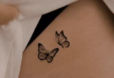 two butterflies on the back of a woman's stomach