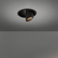 an image of a ceiling light that is in the middle of a room with gray walls