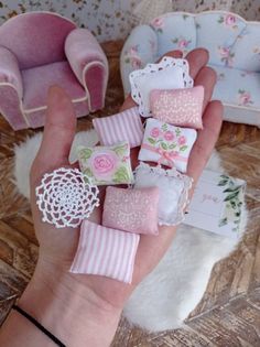 a hand holding several miniature pieces of fabric