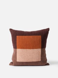 a brown and tan pillow sitting on top of a white table