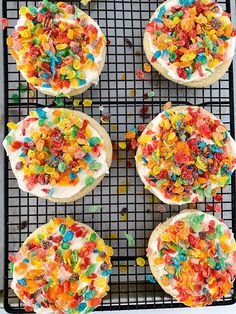 four desserts on a cooling rack with sprinkles and colored candies