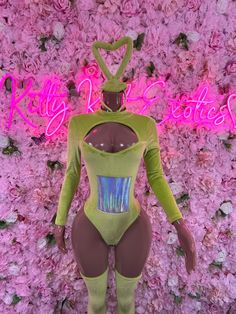 a mannequin is standing in front of a flower wall with the words kitty kratch on it