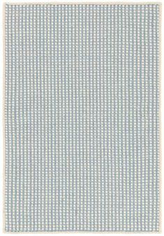 a blue and white rug with small squares on it