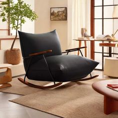 a living room with a rocking chair and rug