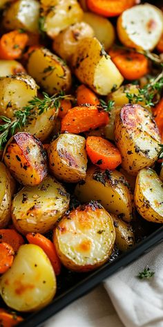 roasted potatoes and carrots with herbs on top