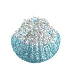 a blue ornament with white and silver glitters on the top, sitting in front of a white background