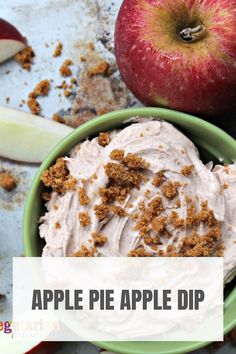 an apple pie dip in a green bowl next to sliced apples and cinnamon crumbs