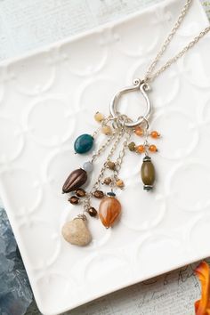 Brighten your look with this beautiful layer from the Vitality Collection! Featuring tassels with a stunning color way, it's the perfect accessory for any occasion. Sterling Silver (Lead & Nickel Free) Apatite, Orange Jade, Czech Glass 29.75-31.75" adjustable length, with sterling silver lobster claw clasp We hand select our natural materials, thus there may be slight variations in color and/or size that will not detract from the overall aesthetic. Our unique handcrafted designer jewelry for wom Cheap Czech Glass Necklaces With Polished Beads, Luxury Czech Glass Necklaces, Cheap Gold Necklaces With Czech Glass, Floyd Va, Silver Gold Earrings, Silver Gold Necklace, Czech Glass Jewelry, Cluster Necklace, Gold Collection