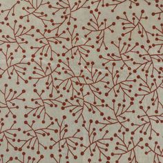 a red and white pattern on fabric with small dots in the center, as well as berries