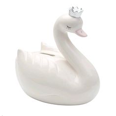 a white swan with a crown on its head is sitting in front of a white background