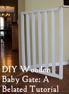 a baby gate that is in the middle of a room with an open door and text overlay reading diy wooden baby gate a belated